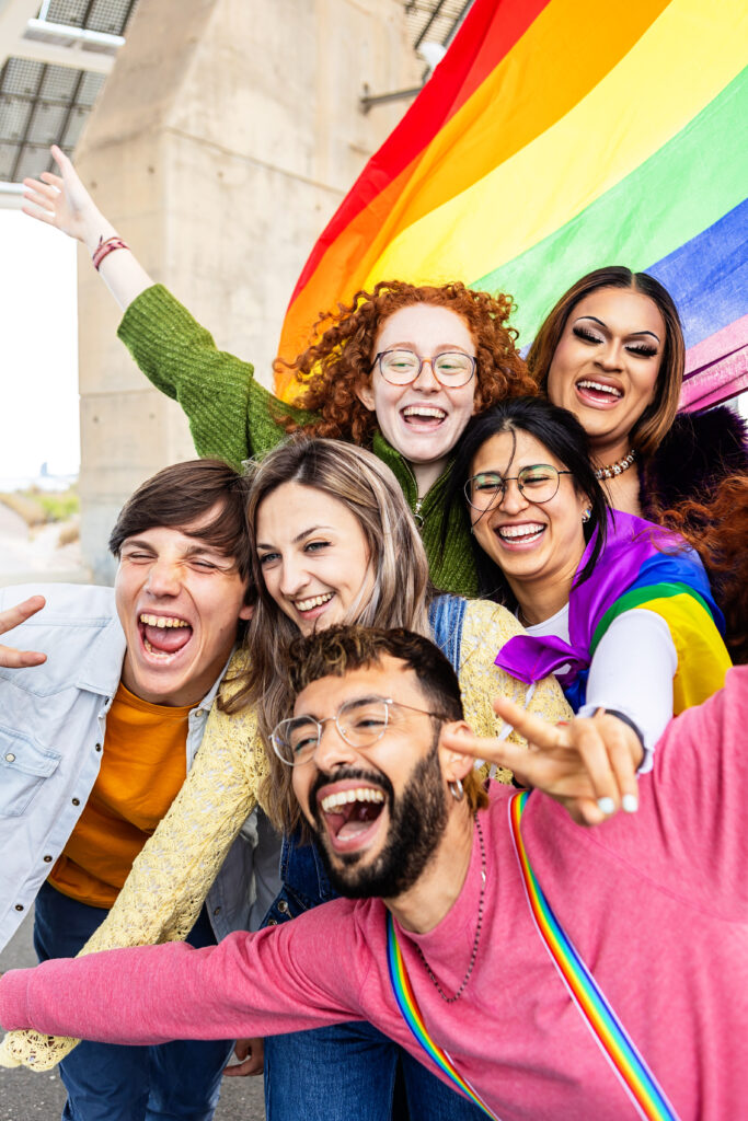 Happy group of young people celebrating gay pride day festival