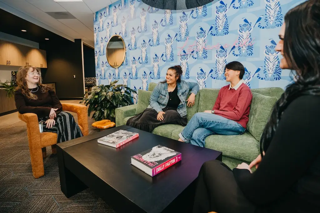 Small group conversation in the lounge at Chroma Wellness Center, an LGBTQ+ affirming outpatient mental health treatment center in Denver.