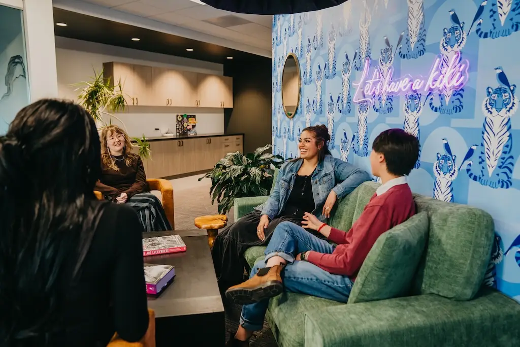 Small group conversation in the lounge at Chroma Wellness Center, an LGBTQ+ affirming outpatient mental health treatment center in Denver.