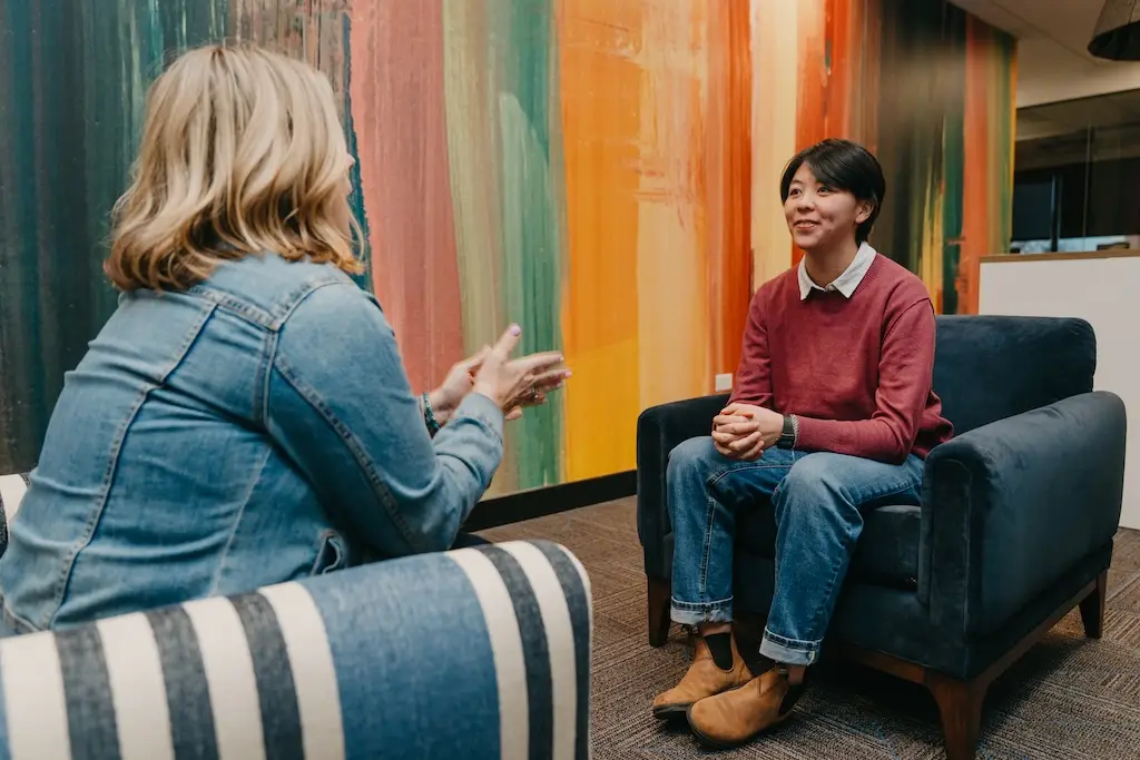 Therapist and client talking during a counseling session at Chroma Wellness Center, an LGBTQ+ affirming outpatient mental health treatment center in Denver.