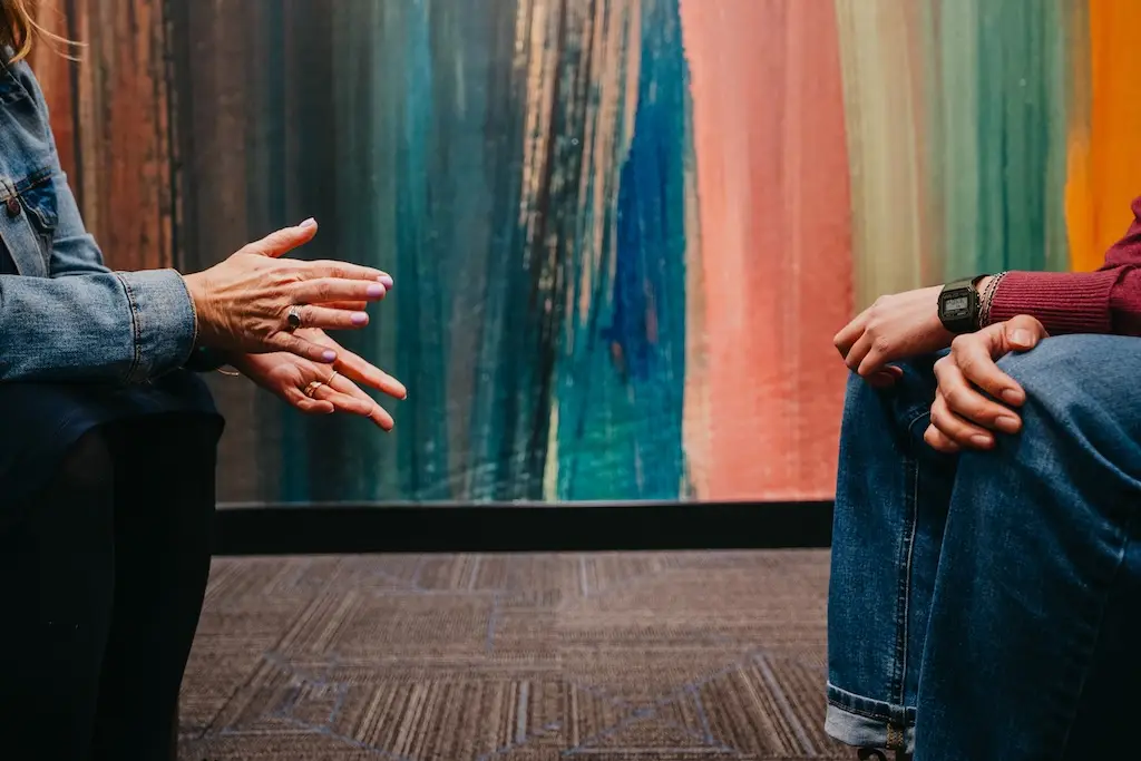 Therapist speaking with client during LGBTQIA+ affirming mental health treatment session at Chroma Wellness Center in Denver, Colorado.