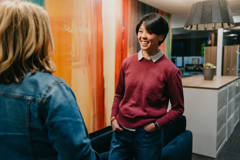 Two people talking in a common area at Chroma Wellness Center, an LGBTQ+ affirming outpatient mental health treatment center in Denver.