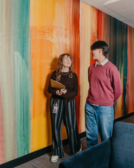 A quiet moment of connection between peers in an identity-affirming, supportive mental health and trauma treatment environment at Chroma Wellness Center