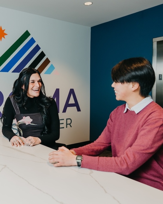 Clients talking in the lobby at Chroma Wellness Center, an LGBTQ+ affirming outpatient mental health treatment center in Denver.