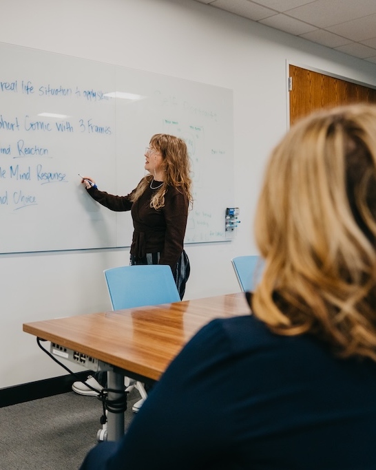 Therapist teaching coping skills during a group therapy session at Chroma Wellness Center in Denver.