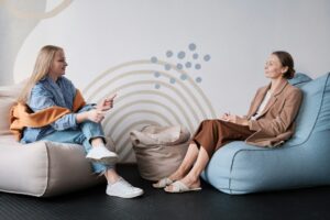 Client and therapist in a relaxed seating arrangement during a structured outpatient therapy session, reflecting supportive care in a PHP or IOP setting