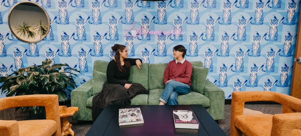 Two people talking in the welcoming lobby at Chroma Wellness Center, representing connection and affirming mental health, trauma, and addiction support.