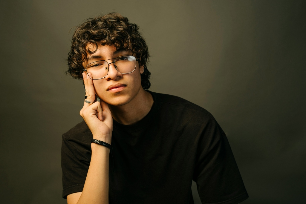 Young adult with a thoughtful expression representing neurodiversity, identity, and gender exploration.