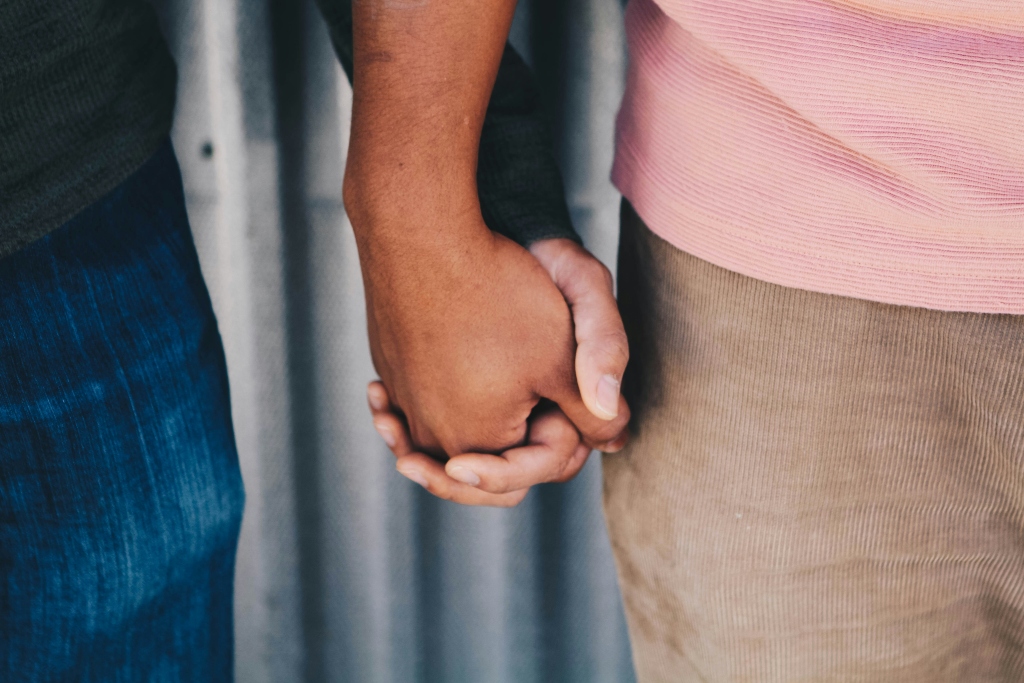 Two people holding hands, representing emotional connection and relationships in an article about attachment disorders.